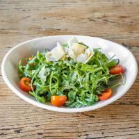 Rucola Salad · Arugula, Cherry tomatoes, Parmigiano, Lemon