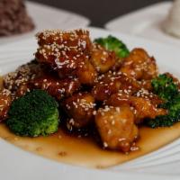 Sesame Chicken · Tossed in sweet wine sauce topped with roasted sesame seeds served with steamed broccoli.