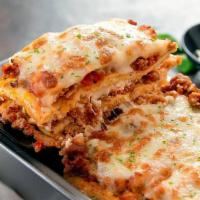 Lasagna  · Two layers,
Ground Beef,
Ricotta Cheese,
Served with Garlic Bread