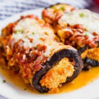 Eggplant Rollatini · Eggplant Plant rolled with ricotta and mozzarella  baked in tomato sauce, served with side s...