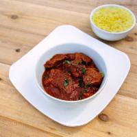 Lamb Curry · Boneless lamb with tomato onion based sauce mixed with ginger, garlic and spices.