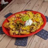 Nachos Bonitos · Corn tortilla chips topped with re-fried beans. Your choice of beef or chicken fajita, melte...