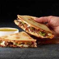 PHILLY CHEESESTEAK PAPADIA · Flatbread-style sandwich with Philly sauce, cheese, steak, onions and green peppers. Served ...