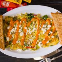 Mediterranean Omelette · 3 eggs with broccoli, spinach, onions, peppers, tomato, and feta cheese topped with chipotle...