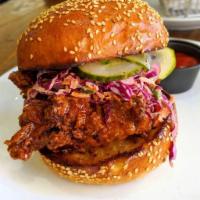 Spicy Buttermilk Sandwich · Crispy chicken tossed in honey sriracha, homemade purple slaw, pickles on potato roll