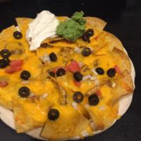 Nachos · Chips with cheese, beans, onions, tomatoes, olives, sour cream and fresh guacamole. Add beef...