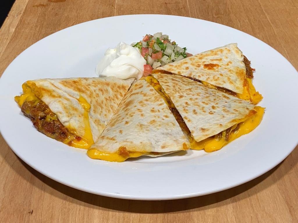 Quesadilla · 2 flour tortillas grilled with cheese, topped with sour cream and pico de gallo.