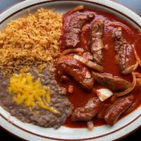 Chile Colorado · Sirloin strips sauteed medium in a spicy red sauce. Served with rice and beans. Choice of to...