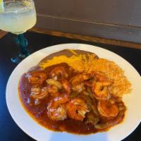 Spicy Prawns · Prawns sauteed with onions and peppers in a spicy red sauce. Served with rice and beans. Cho...