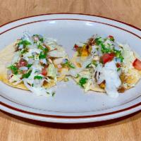 Fish Tacos  (2) · Two soft corn tortillas. Blackened grilled cod,shredded cabbage,dressing pico de gallo and s...