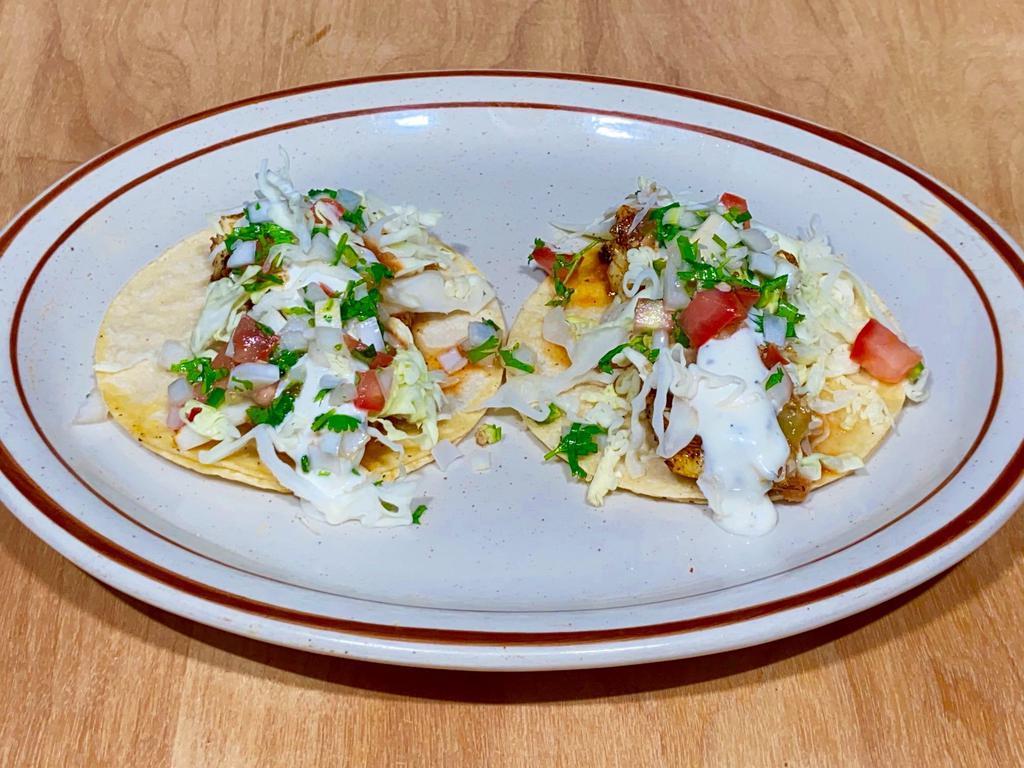 Fish Tacos  (2) · Two soft corn tortillas. Blackened grilled cod,shredded cabbage,dressing pico de gallo and salsa.