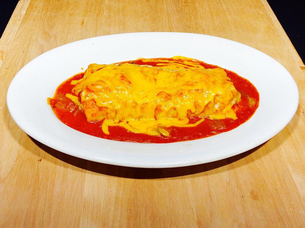Burrito Plate · Flour tortilla filled with ground beef, simmered chicken, or green chile pork, topped with sauce & cheese.