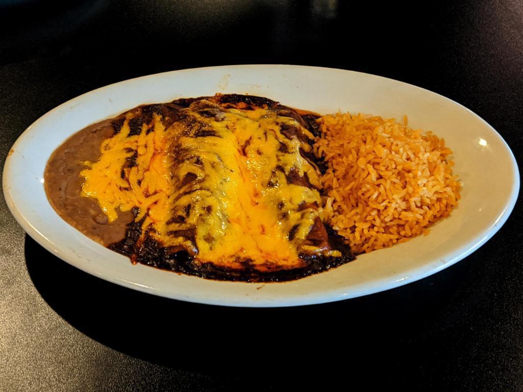 Enchiladas Plate (2) ·  2 corn tortillas filled with beef, chicken, cheese or pork, topped with sauce and melted cheddar . Served with rice & beans.