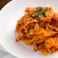 Fettuccine Bolognese · Homemade fettuccine with meat sauce.