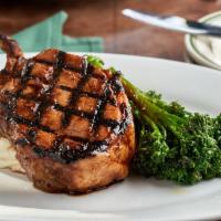 Pork Chop · Double cut frenched pork chop, cooked Frasher's style, roasted garlic mash and broccolini.