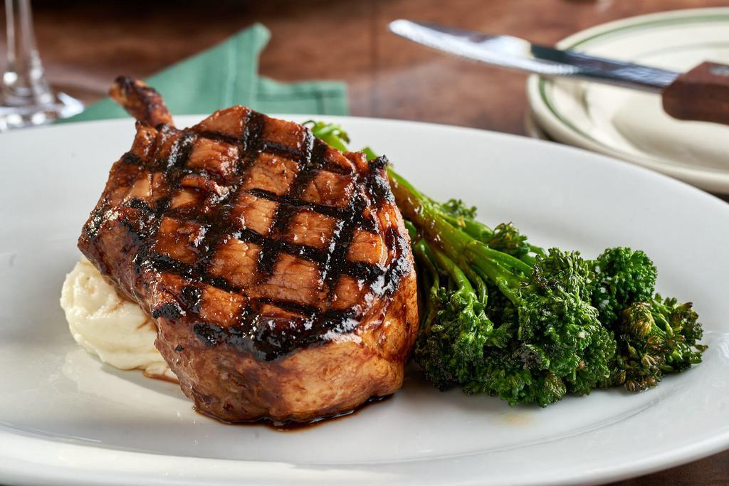 Pork Chop · Double cut frenched pork chop, cooked Frasher's style, roasted garlic mash and broccolini.