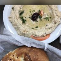 2. Baba Ghanoush · Grilled eggplants with puree of garlic herbs and virgin olive oil. Served with warm bread.