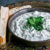 4. Tzatziki · Homemade yogurt, diced cucumbers, oregano, fresh dill, mint and hint of garlic. Served with ...