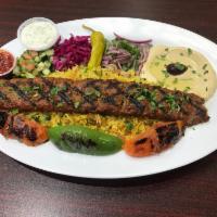 34. Adana Kebab · Skewered minced lamb and beef, flavored with spices. Served with homemade bread, rice, salad...