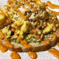 Street Corn Toast · Sourdough toast with a guacamole spread topped with roasted jalapeno corn, Cotija cheese and...