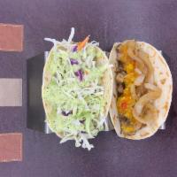Jerk Chicken Taco (GF) · Jerk spiced chicken. mango salsa. grilled onions and peppers. fresh slaw mix. house sauce