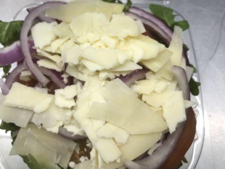 Arugula Salad · Baby arugula, red onion, tomatoes and Parmesan cheese with balsamic vinaigrette.