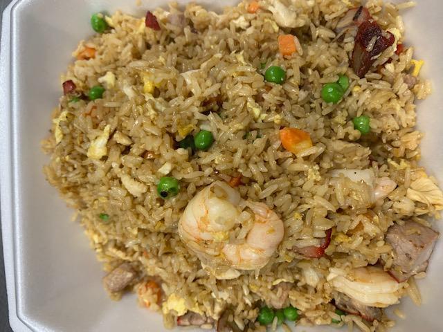 M7. House Special Fried Rice · Wok-fried rice with eggs, peas, carrots, chicken, shrimp, pork and seasonings in a light soy sauce.
