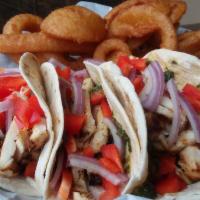 Locos Tacos · (3) soft tacos loaded with grilled chicken, spicy 4-pepper cilantro sauce, red onions and re...