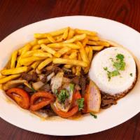 LOMO SALTADO · Peruvian Stir-Fried beef, tomatoes, red onions, soy sauce, and cilantro served with fries & ...
