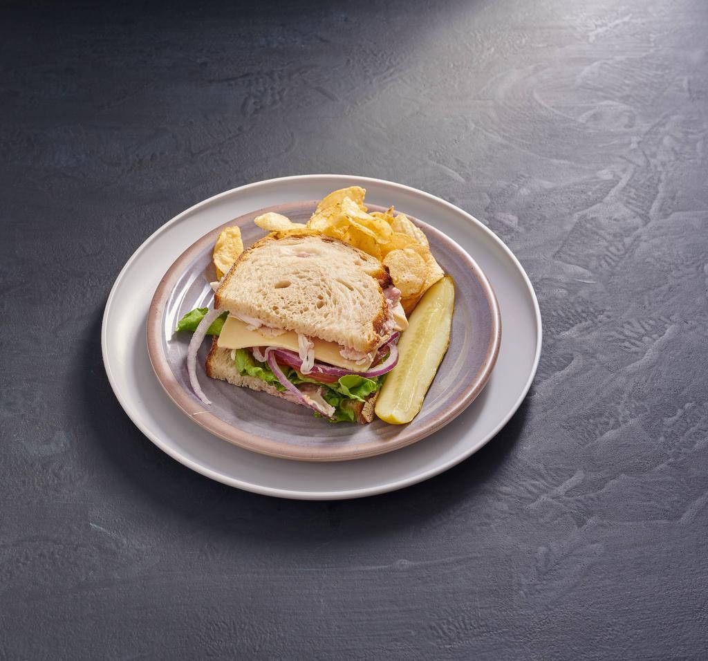 Turkey · Oven-roasted turkey, Havarti cheese, lettuce, tomato, red onion, and cranberry mayo on sourdough.