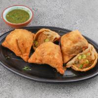 Samosa · Hand rolled pastry stuffed with potato and peas.
