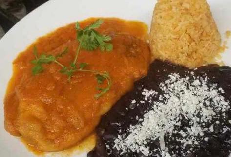 Chile Relleno con picadillo · Fire Roasted Poblano chile, chihuahua cheese & ground beef, coated w/ egg batter served w/ morita chile- light tomato broth, rice and beans.