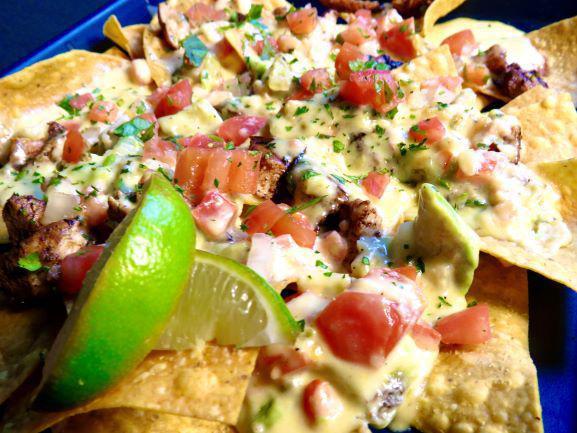 Hole 9 Nachos · Chicken or steak, made daily tortilla chips and melted mozzarella cheese, smothered in our 1 of a kind made to order avocado cream sauce. 