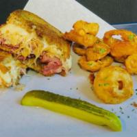 Ruben Sandwich · Pastrami seasoned to perfection, cooked and topped with house picked sauerkraut, melted Swis...