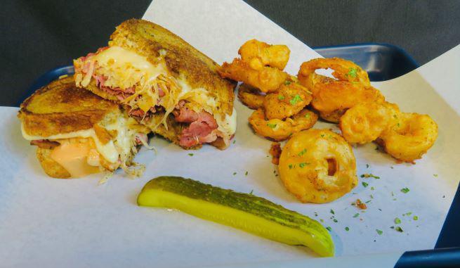 Ruben Sandwich · Pastrami seasoned to perfection, cooked and topped with house picked sauerkraut, melted Swiss and drenched in our famous Caddy sauce.
