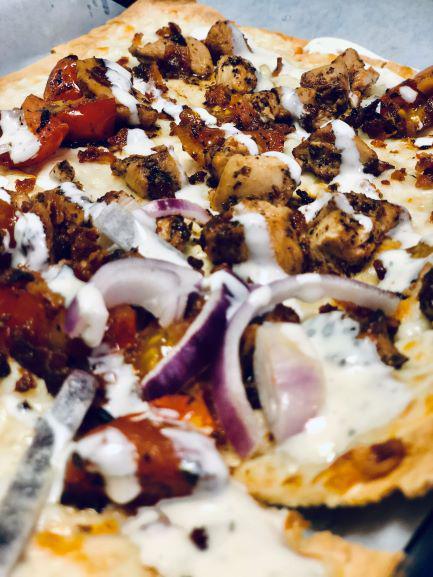 Chicken Bacon Ranch  · Marinated chicken over melted mozzarella teamed up with sauteed cherry tomatoes, red onion and bacon ranover with ranch.