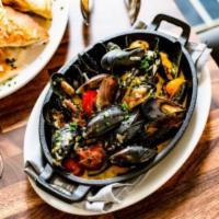 Mussels · Spanish chorizo, garlic, chardonnay, blistered tomatoes, herbed butter, capers, grilled coun...