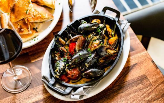 Mussels · Spanish chorizo, garlic, chardonnay, blistered tomatoes, herbed butter, capers, grilled country bread.