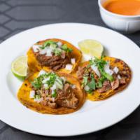 Birria trio tacos · 3 street Birria tacos, fresh onions, cilantro , limes ＆ red salsa -corn tortilla