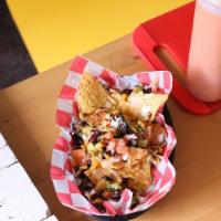 Super Loaded Nachos · Served in a box and topped nacho cheese sauce, jalapeño peppers, reduced-fat sour cream, tom...