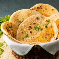 Paneer Kulcha · Leavened flat bread stuffed with paneer(cottage cheese) and then slathered with butter.