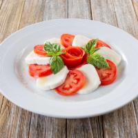 Caprese Salad · Fresh mozzarella cheese with fresh sliced tomato basil and olive oil.