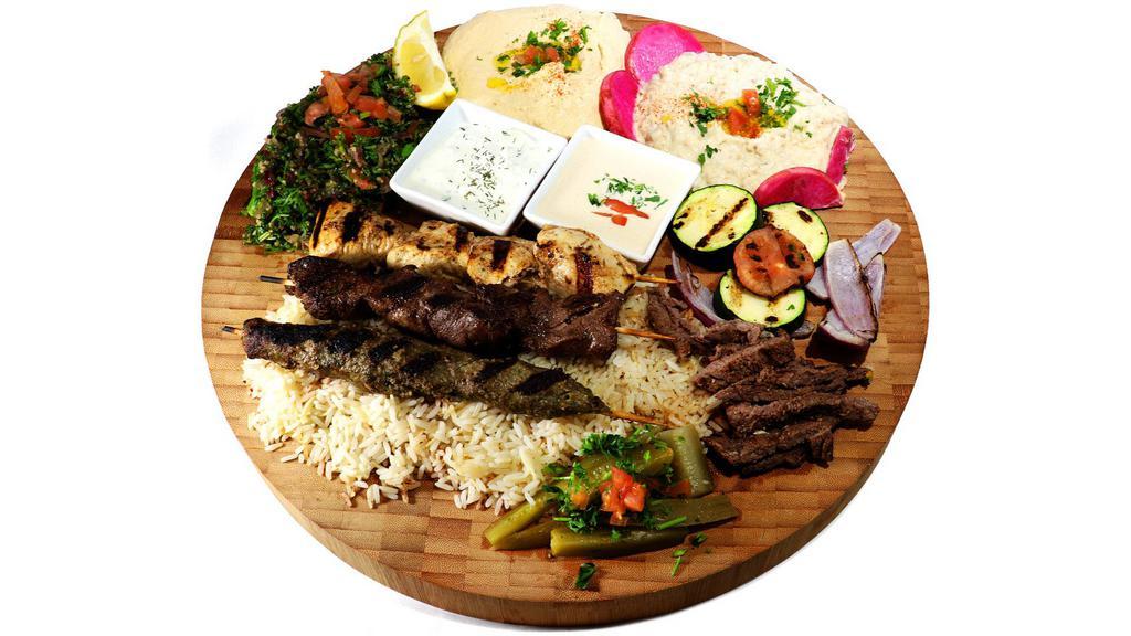 Taste of Lebanon For 2 · 1 skewer each of shish kabob, chicken kabob, kafta and shawarma. Served over rice, hummus, tabouli, baba ghannouge, pickles, pita bread and grilled vegetables.