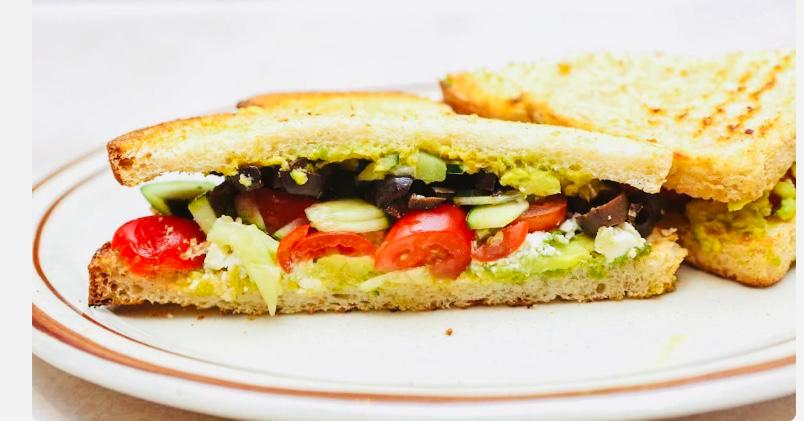 Greek Avocado Toast · Crumbled feta, mashed avocado, cherry tomatoes, chopped cucumbers, chopped Kalamata olives, extra virgin olive oil.