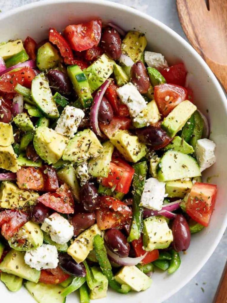 The Greek Avocado Island Salad · Cherry tomatoes, cucumbers, avocado, red onions, feta cheese and Kalamata olives, tossed in olive oil and a touch of salt and oregano.