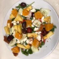 Mediterranean Arugula Fruit Salad · Arugula,Pineapple, Cucumber,Red Onion, grape tomatoes, feta cheese and grapes tossed in oliv...