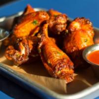 Chicken Wings · Tossed in Buffalo sauce, buttermilk ranch, and celery.