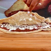 Baleadas Sencillas · Handmade flour tortilla filled with beans, sour cream, and cheese.