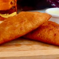 Empanadas · Ground corn dough stuffed with choice of meat sided with special sauce and special dressing.