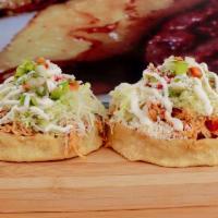 2 Sopes · Corn dough topped with refried beans and choice of meat, cabbage, pico de gallo, pickled oni...